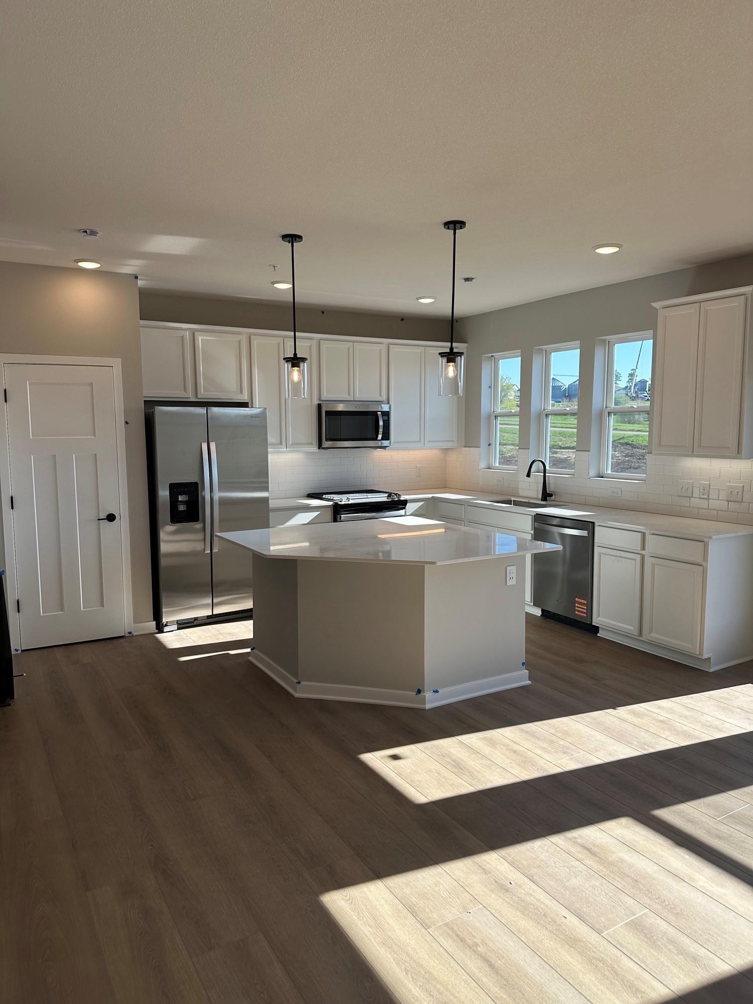 A spacious kitchen with large center island.jpg