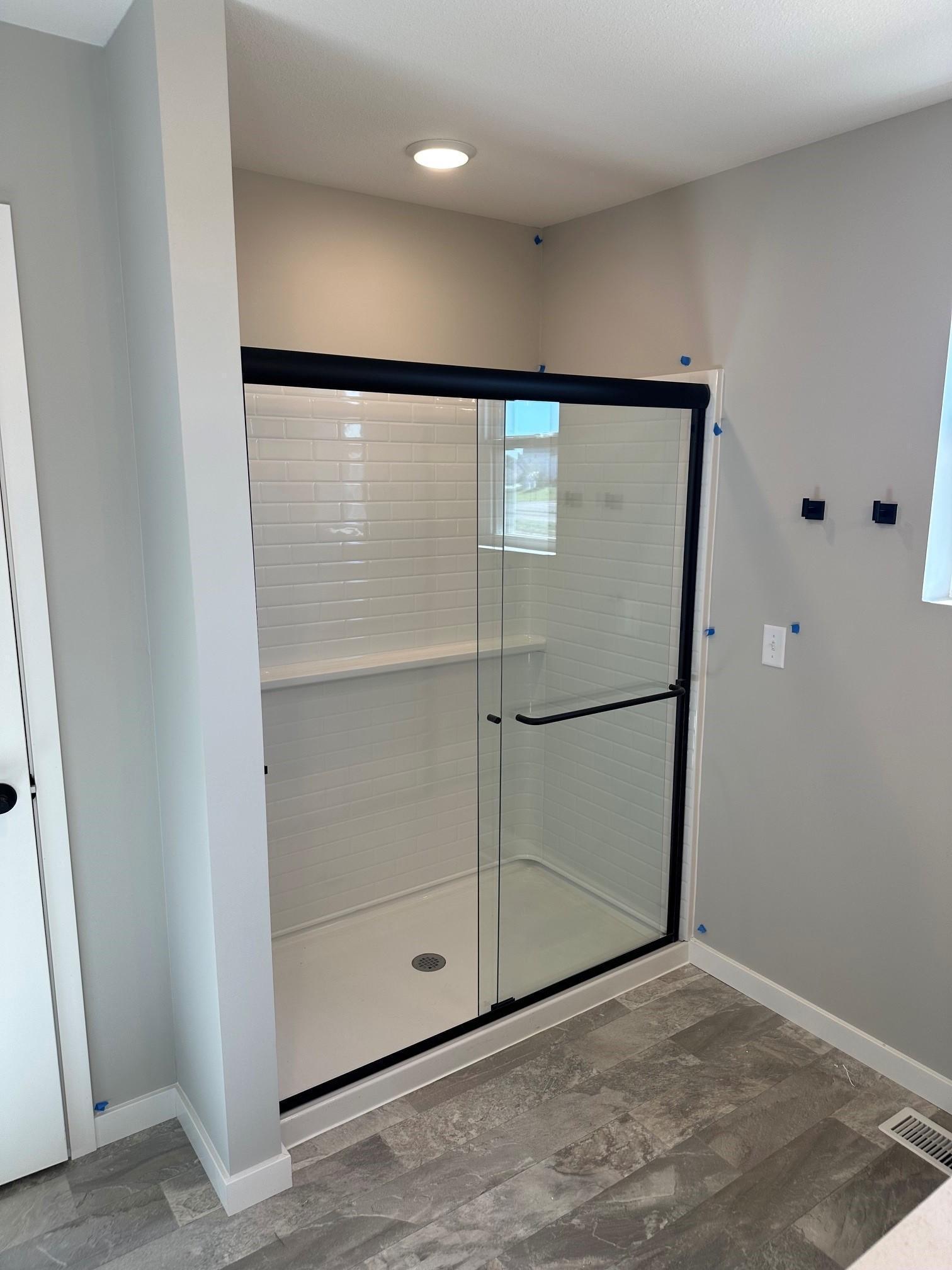 the shower door matches other bath hardware.jpg