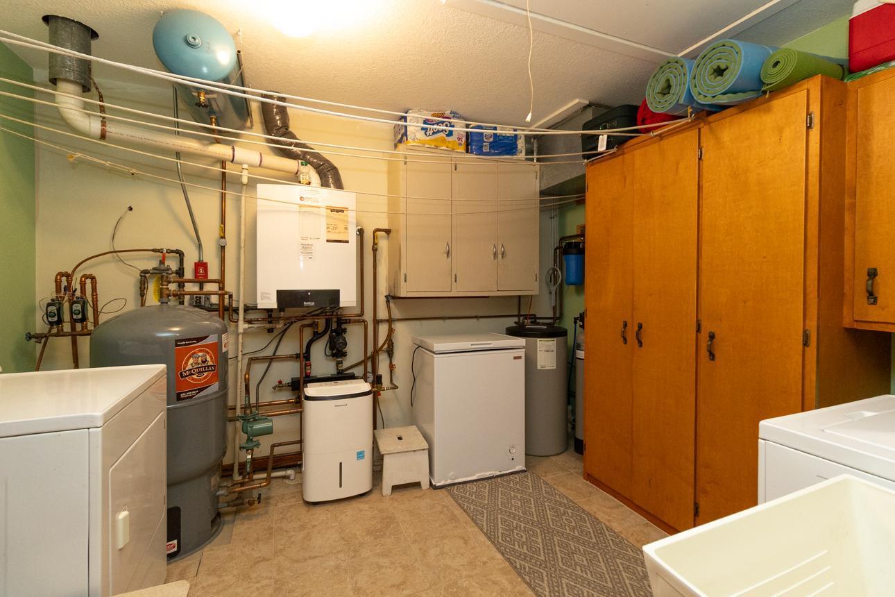 Utility room with washer/dryer and ample storage