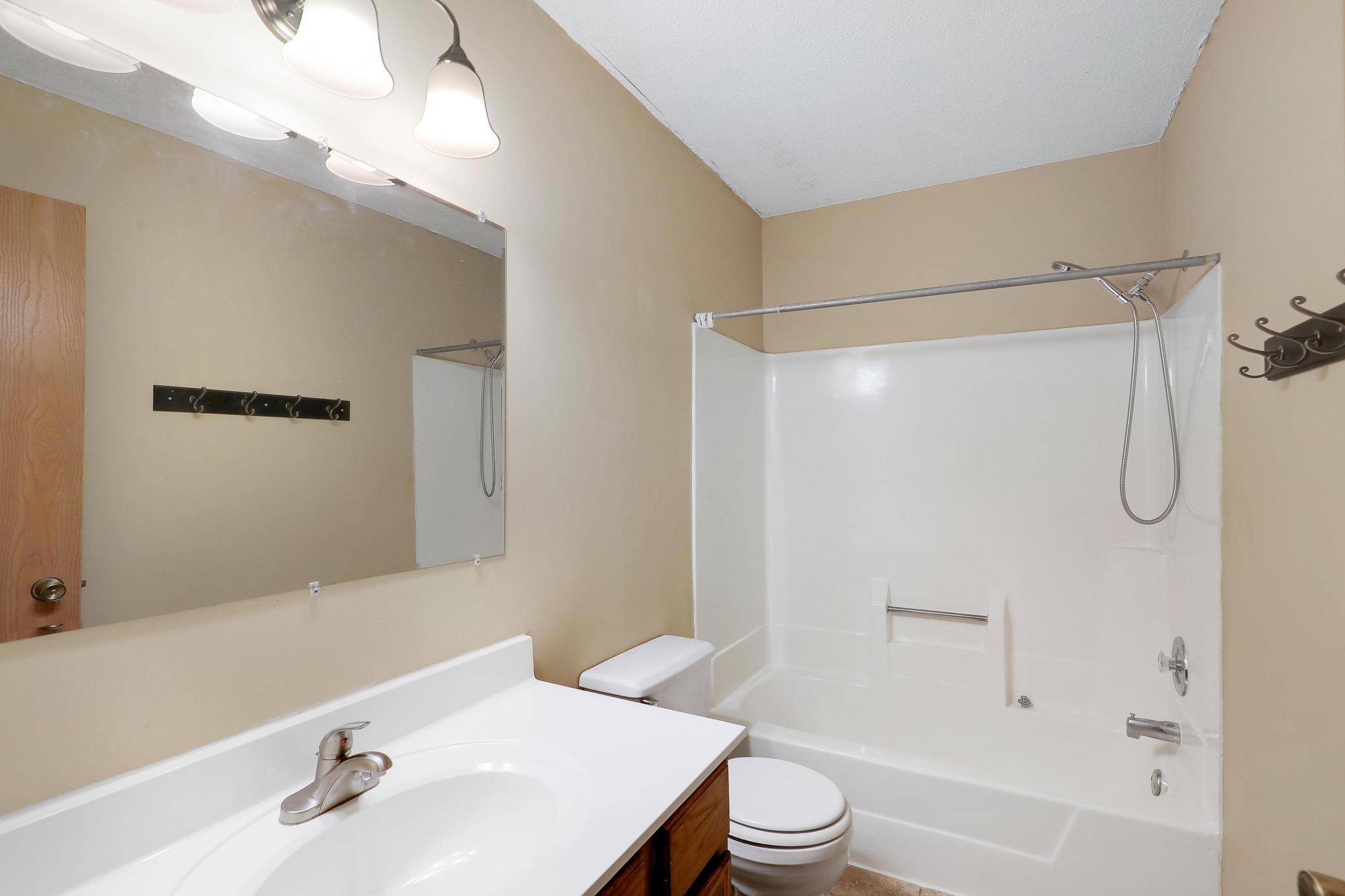 Main bath with ceramic tile and new light fixture
