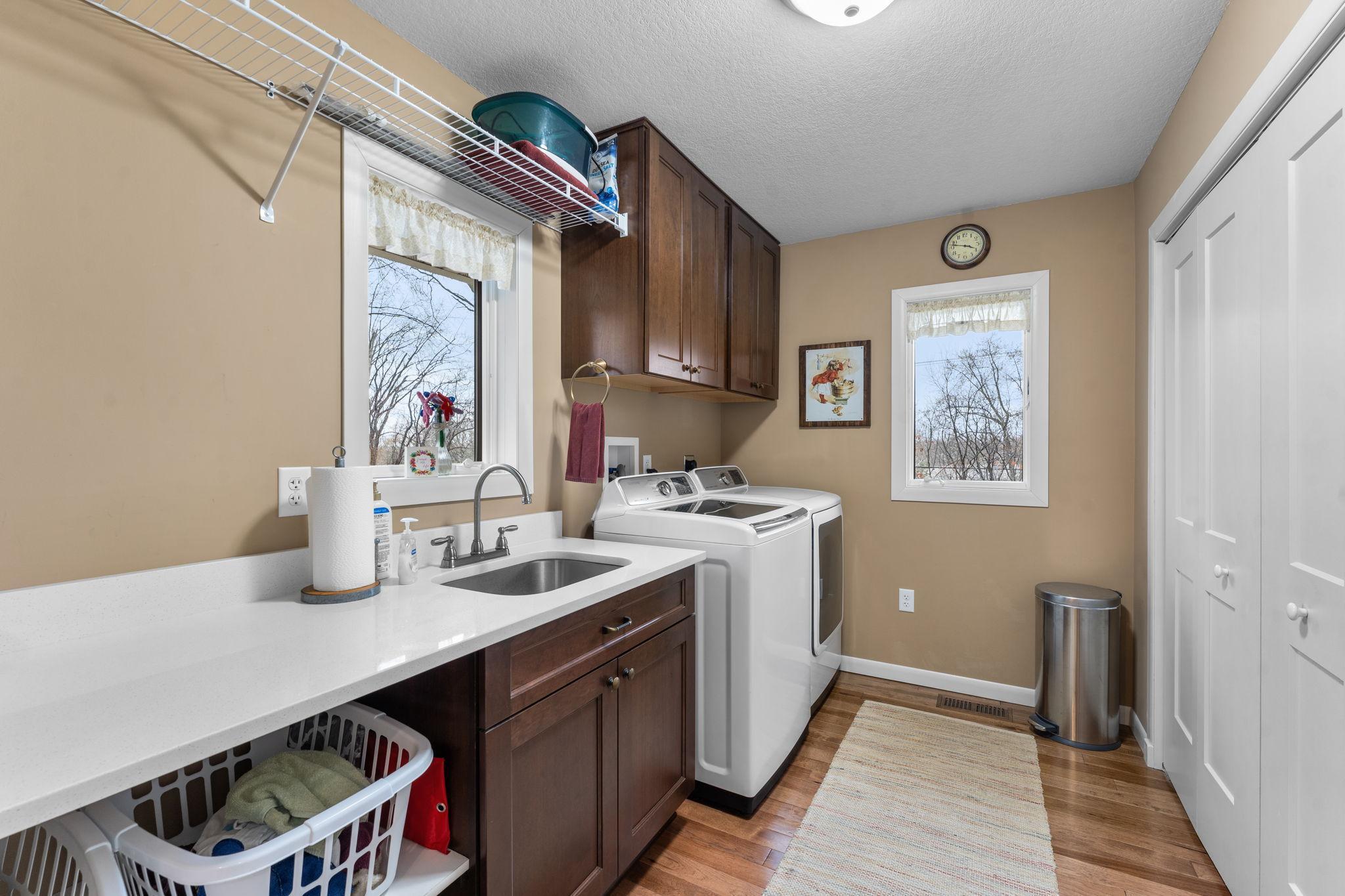 This owner designed laundry room makes that chore much more enjoyable! Look out at the beautiful yard while cleaning clothes!