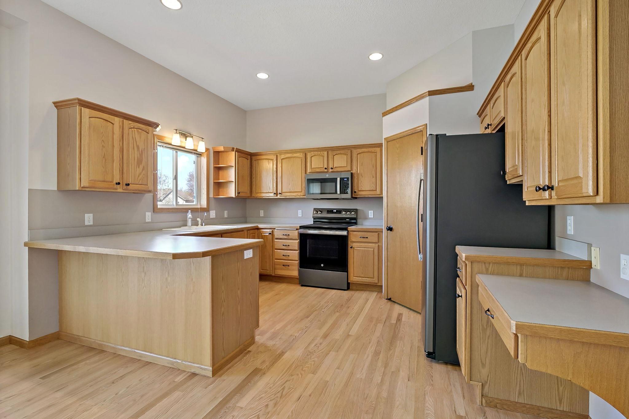 Kitchen with an abundance of both cabinetry & counter space. Note the added wood edging around the counterspace; sets it off