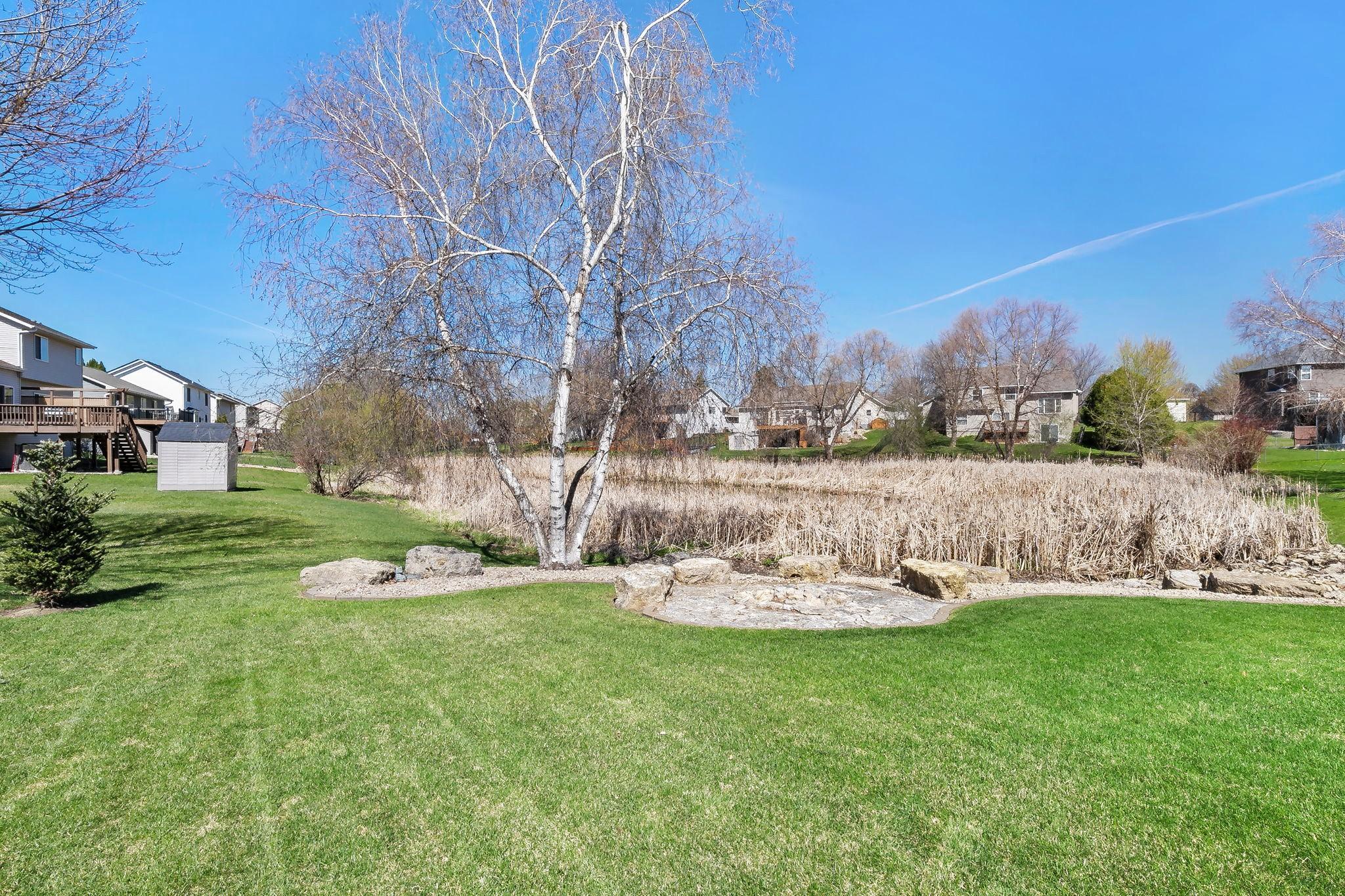 The back yard has space for play and backs up to a serene pond setting. Great spaces!
