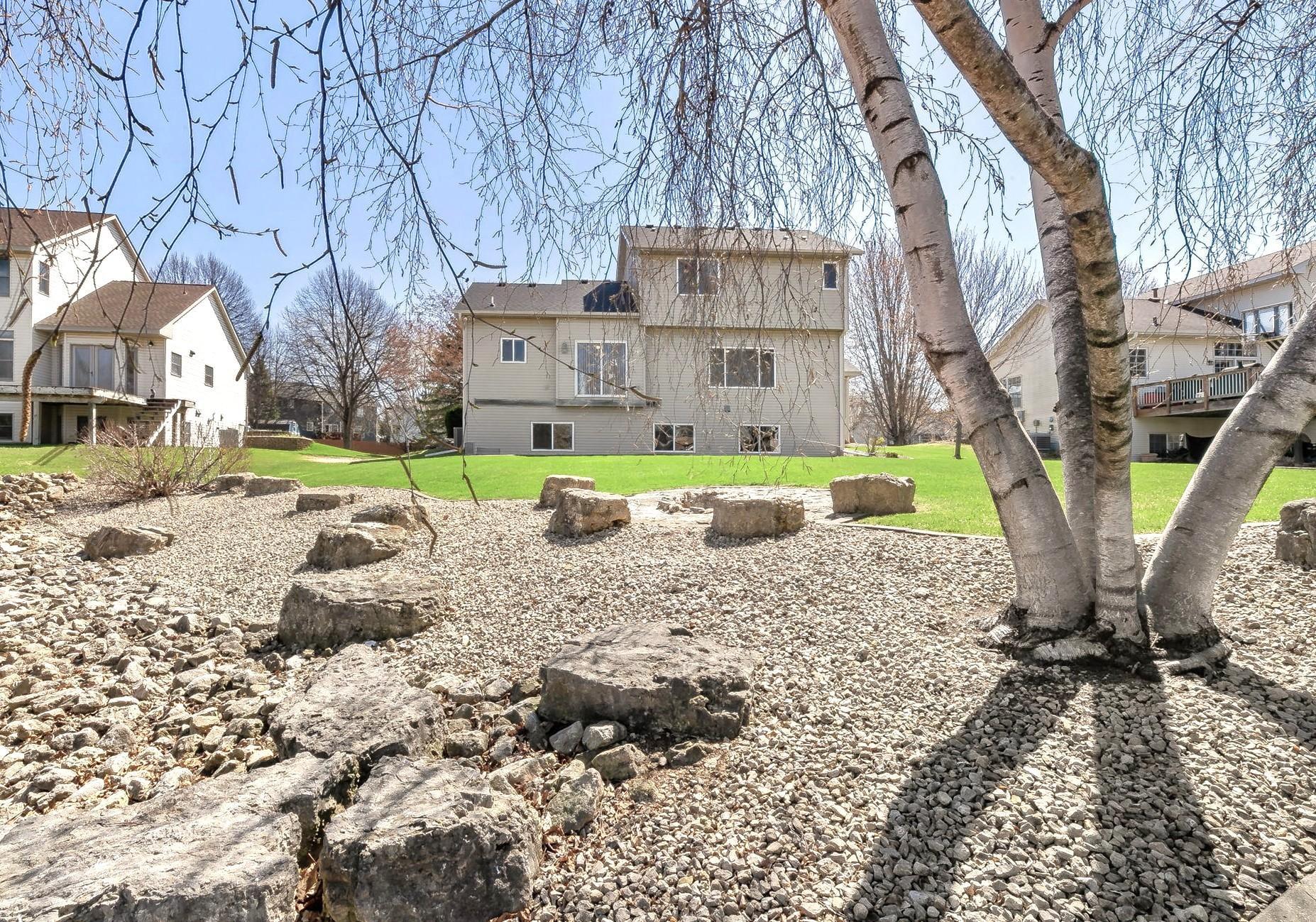 As you walk both the front and back yards you'll note the numerous large limestone boulders brought into the landscaping