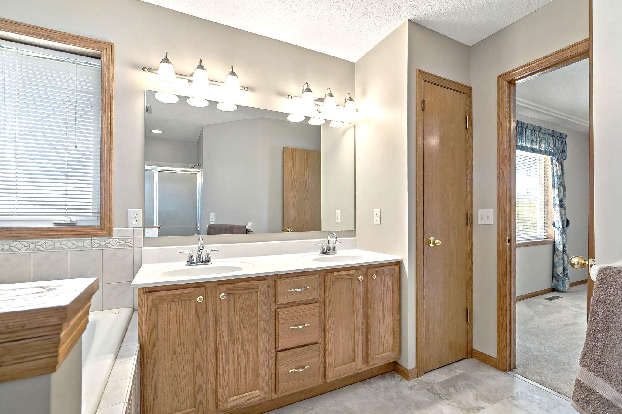Two sinks, large mirror & good storage space, including linen closet