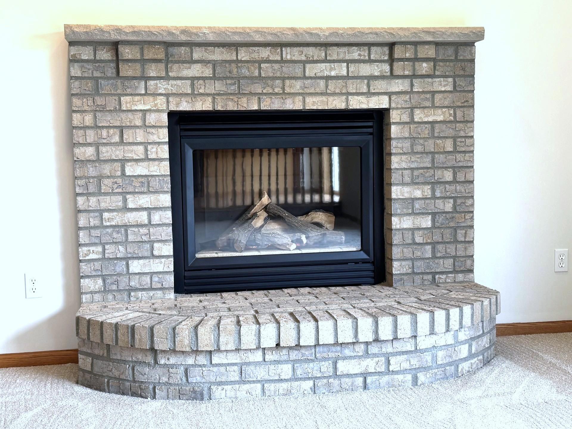 Handsome raised hearth gas Fireplace; with a single piece stone mantel!
