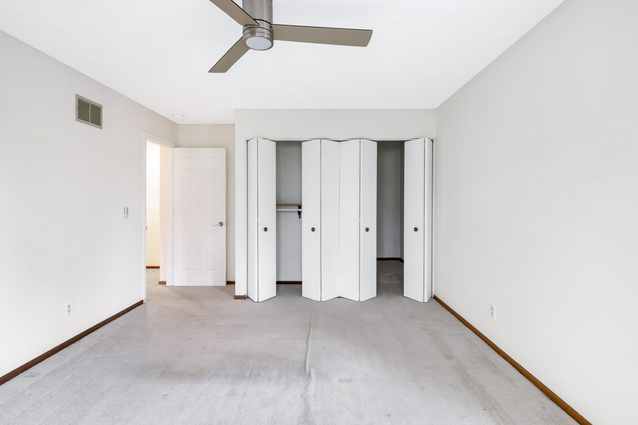 Generous upper-level bedroom with large closet and soft natural light—comfortable and versatile.