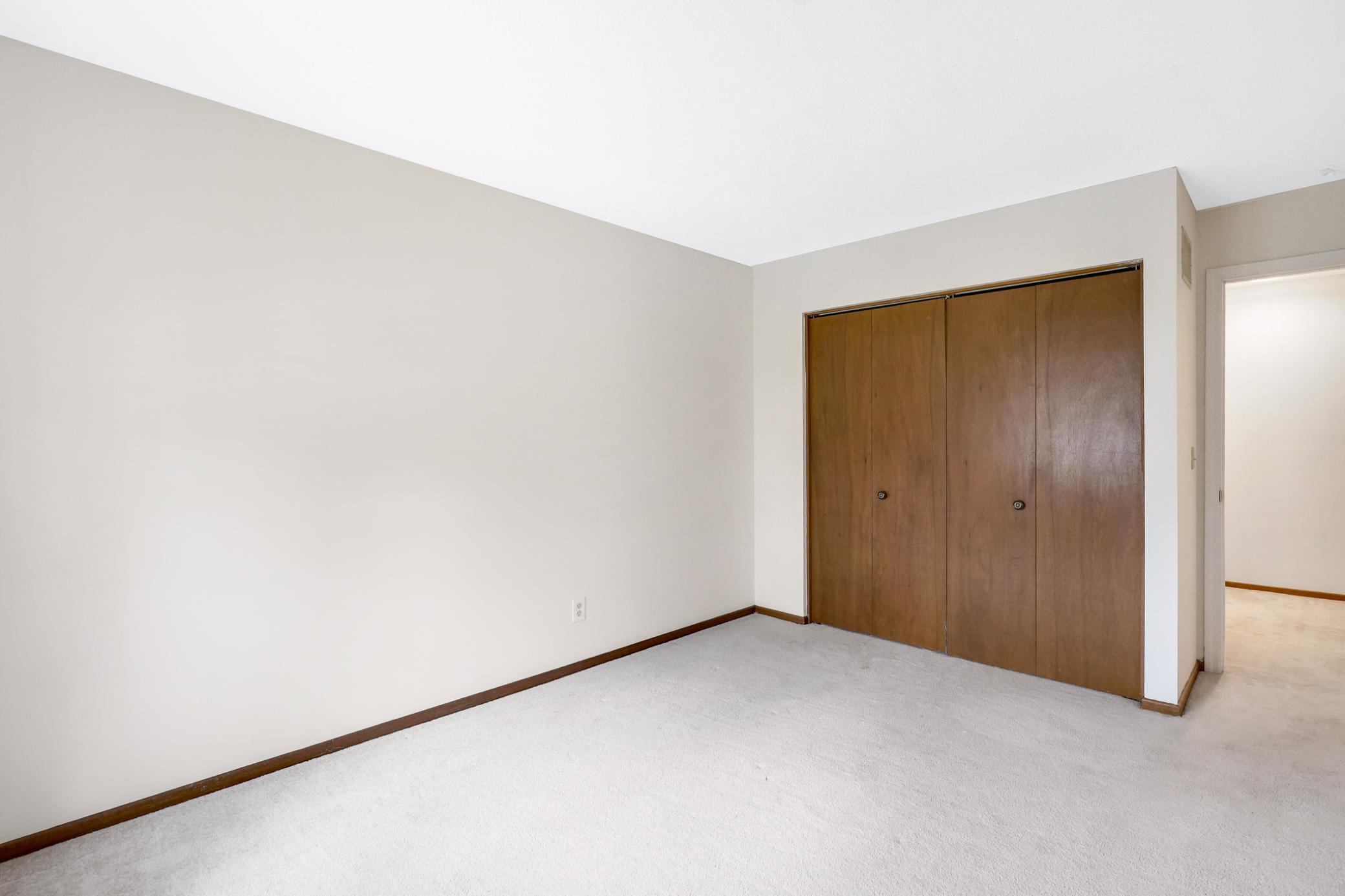 Spacious primary bedroom with multiple windows and great layout flexibility.