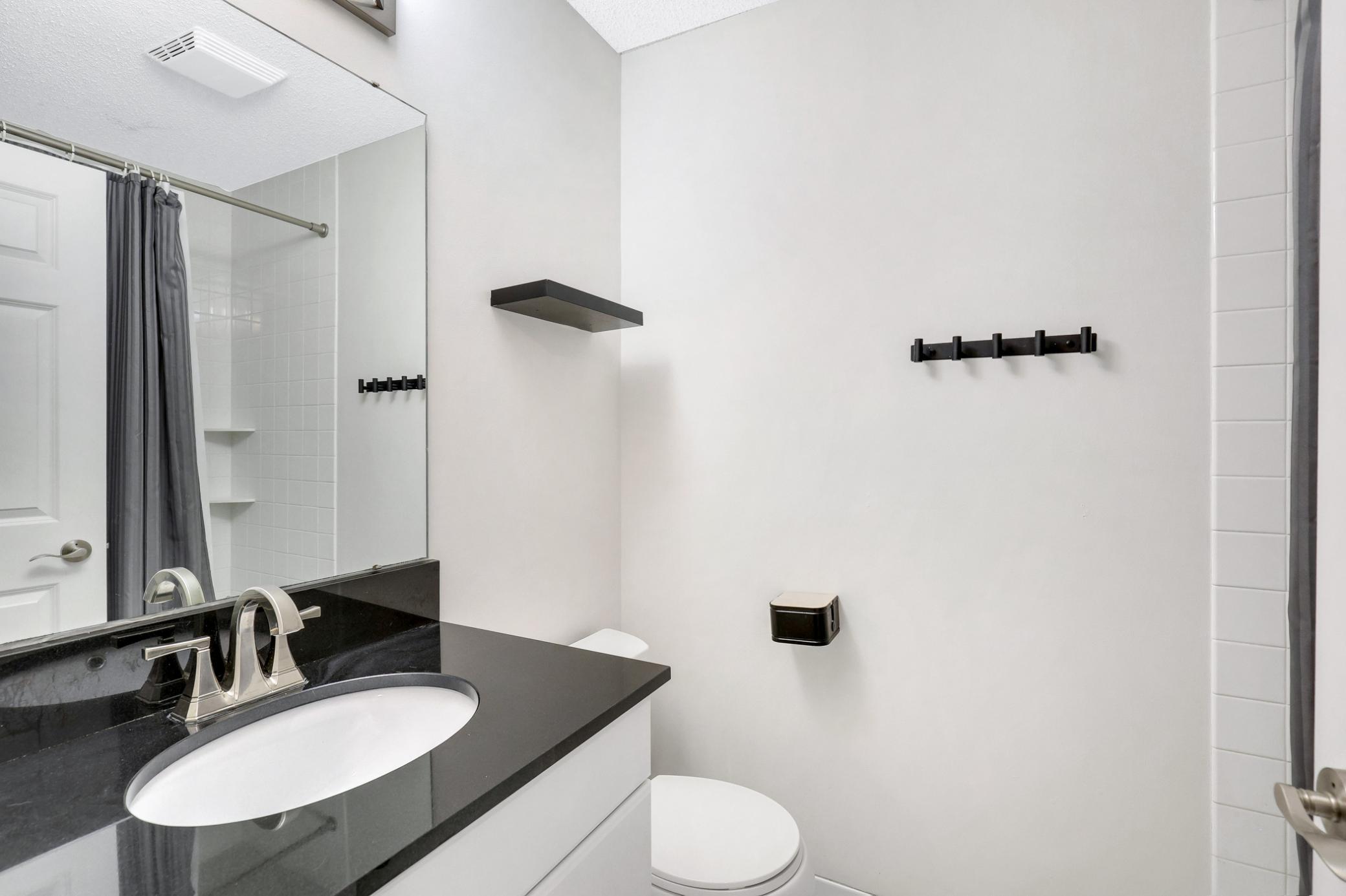 Convenient half bath with modern vanity and fixtures.