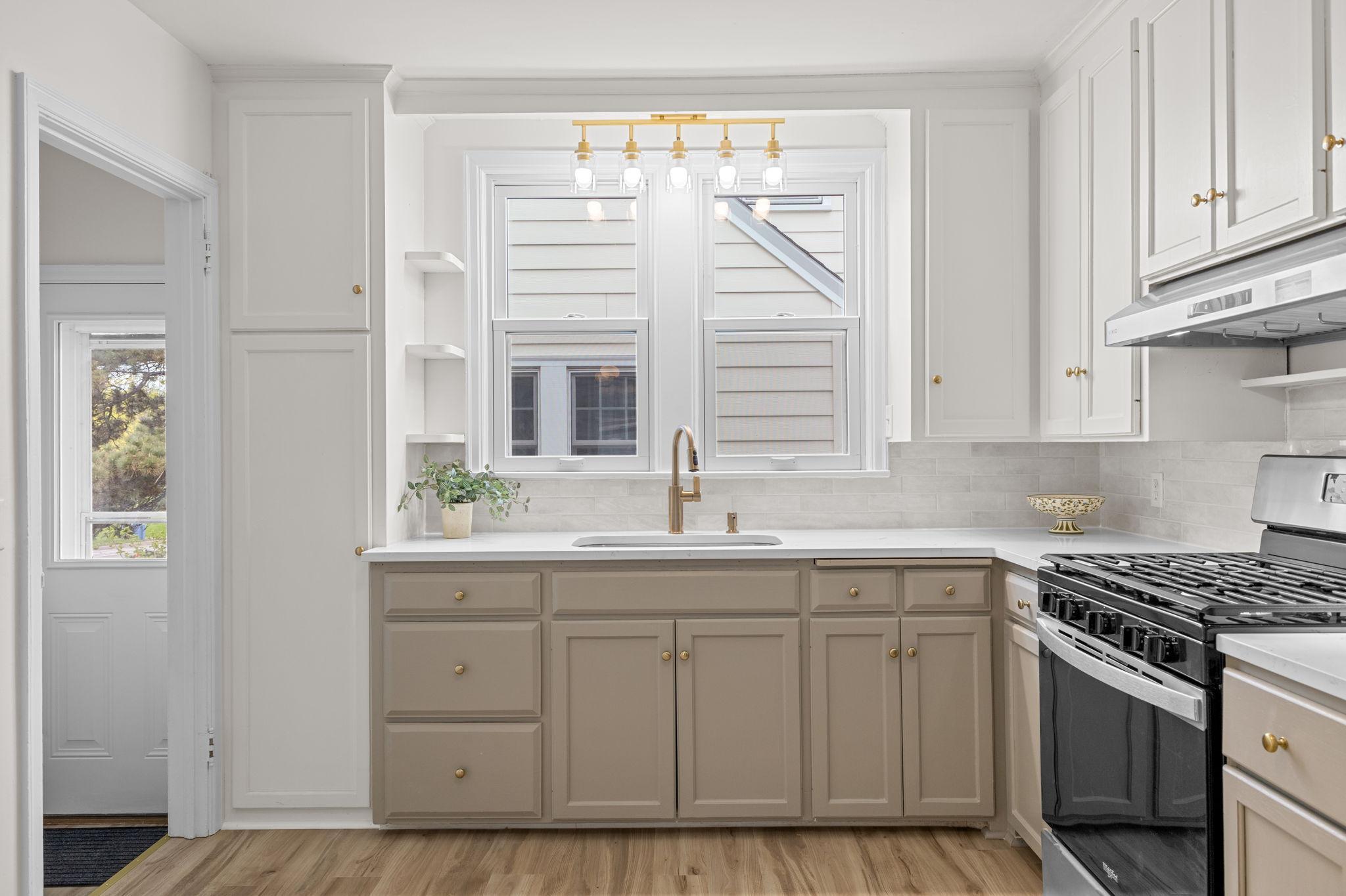 Beautiful tiled backsplash perfectly complements the crisp, warm cabinetry.