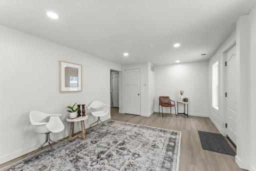 An informal dining area flows seamlessly from the living room, making it a welcoming space for gatherings or everyday meals.