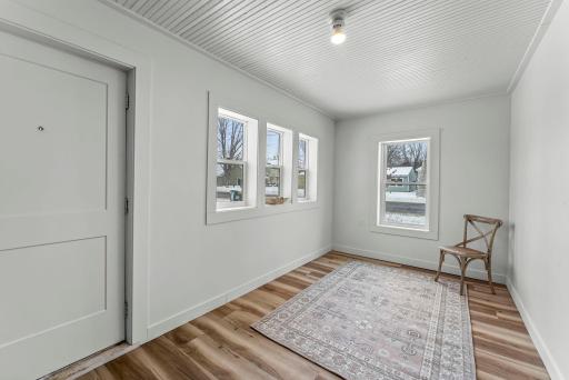 A bright 3-season sunroom expands your living space with abundant windows and a generous storage closet.