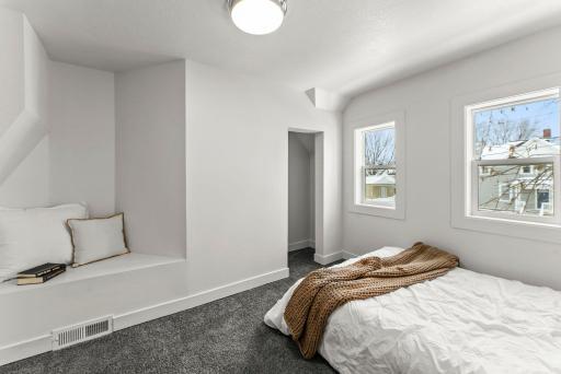 It features plush carpeting and a charming alcove perfect for a reading nook.