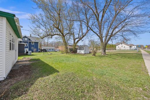 Outside, the spacious corner lot offers mature trees, a storage shed, off-street parking, and convenient alley access. The home also features new, thicker vinyl siding for added durability, along with updated house numbers and a new mailbox.