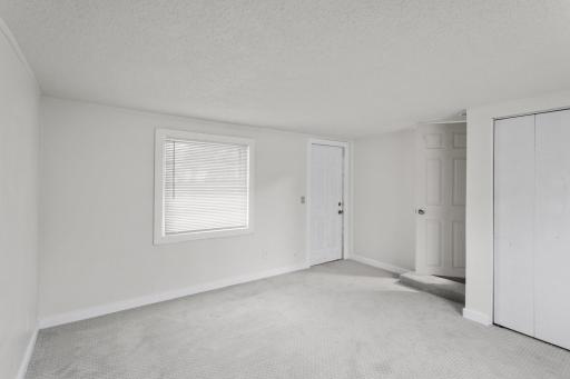 2nd bedroom with entry/exit door to side of the home.