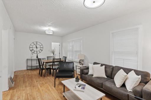 Living room with refinished hardwood floors and fresh paint throughout.