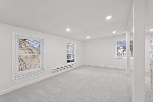 Large upper level bedroom with new carpet and recessed lighting