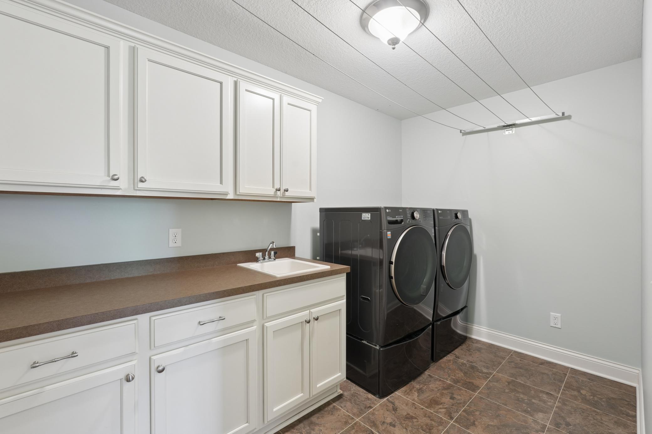 Upper level Laundry with great cabinetry.
