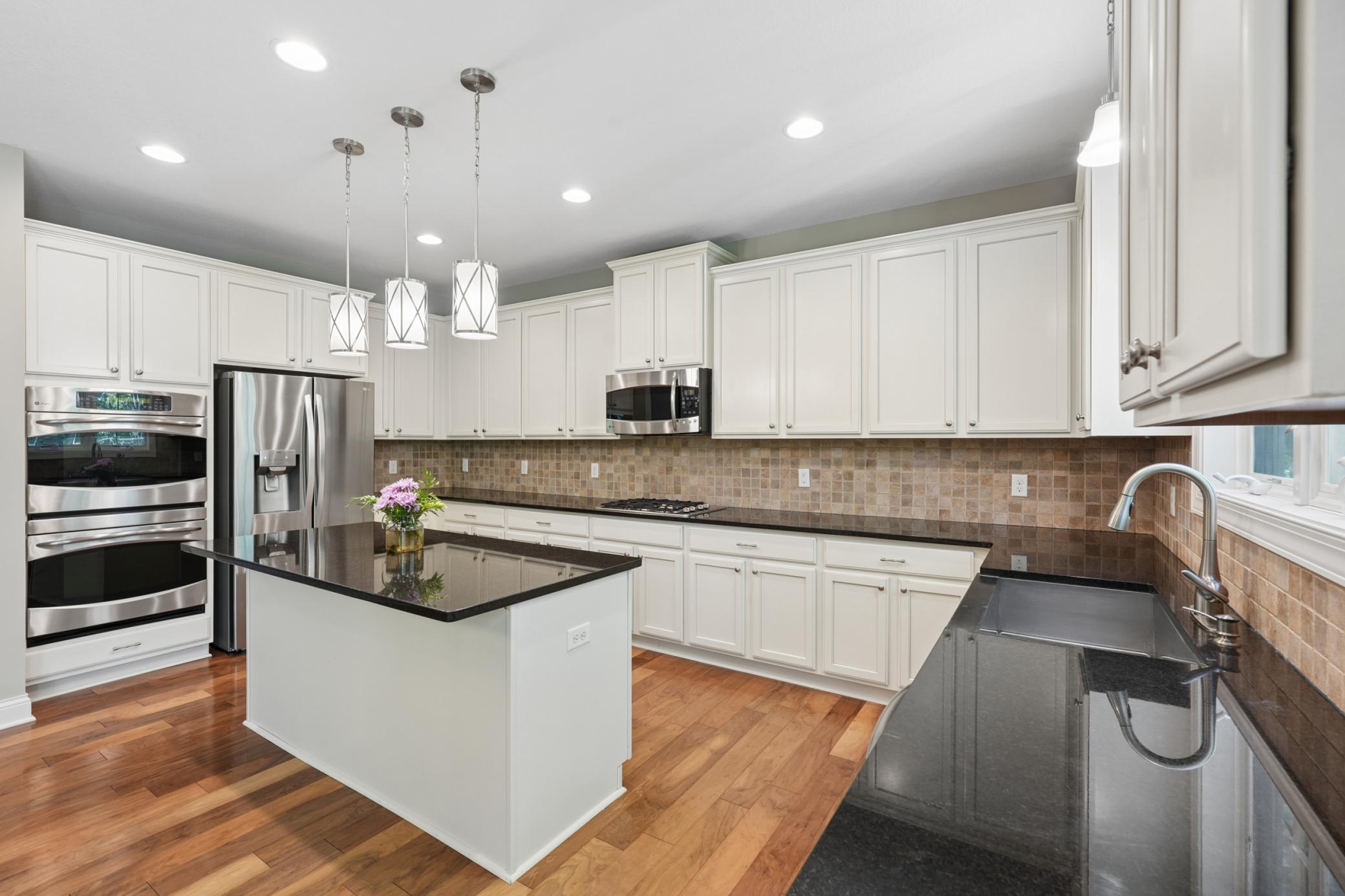 Stainless appliances with gas cooktop and wall ovens.