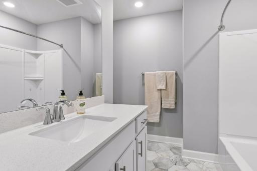 Full bathroom supports the two additional bedrooms on this level.