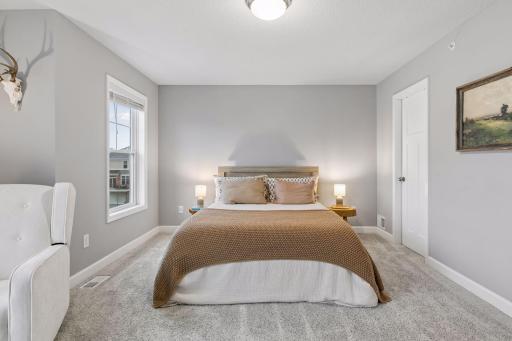 Large primary suite features two closets and a gorgeous en suite bathroom.