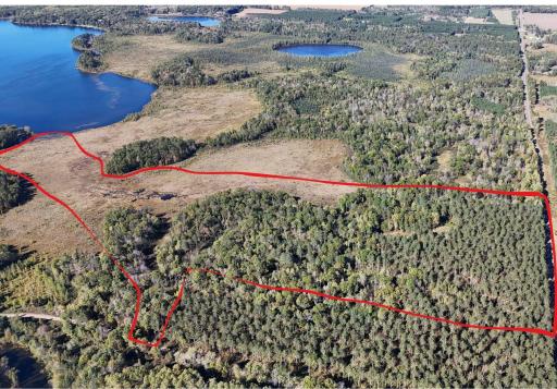 Fantastic Land Tract with access to Spooner Lake. Combination of high ground and lowland is perfect for hunting, building, or just a private retreat.