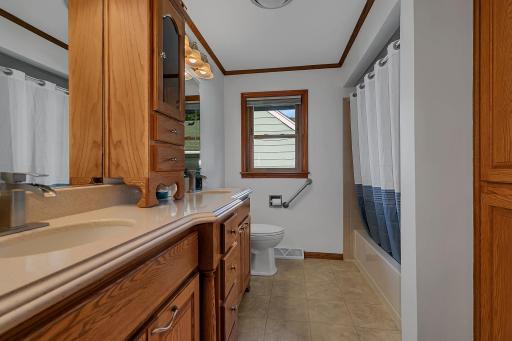 Spacious full bathroom with dual-sink vanitywith abundant storage, updated countertops and beautiful wood cabinetry