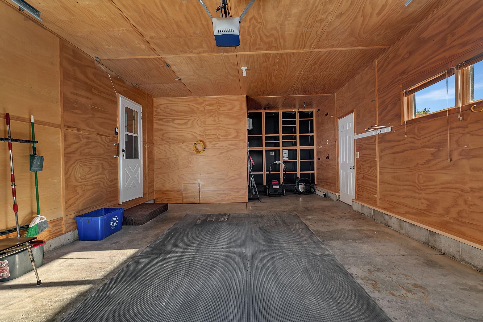 Inside of garage extra long, with storage shelves