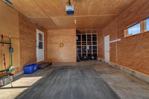 Inside of garage extra long, with storage shelves