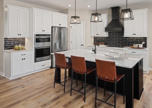 Designed to be the heart of the home, this kitchen offers a standout island, great storage, and a layout built for real life and real moments *Photo of model home, design selections may vary
