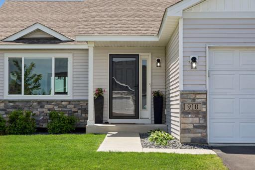 Front porch entry with a sidelight by the front door adds a welcoming touch.