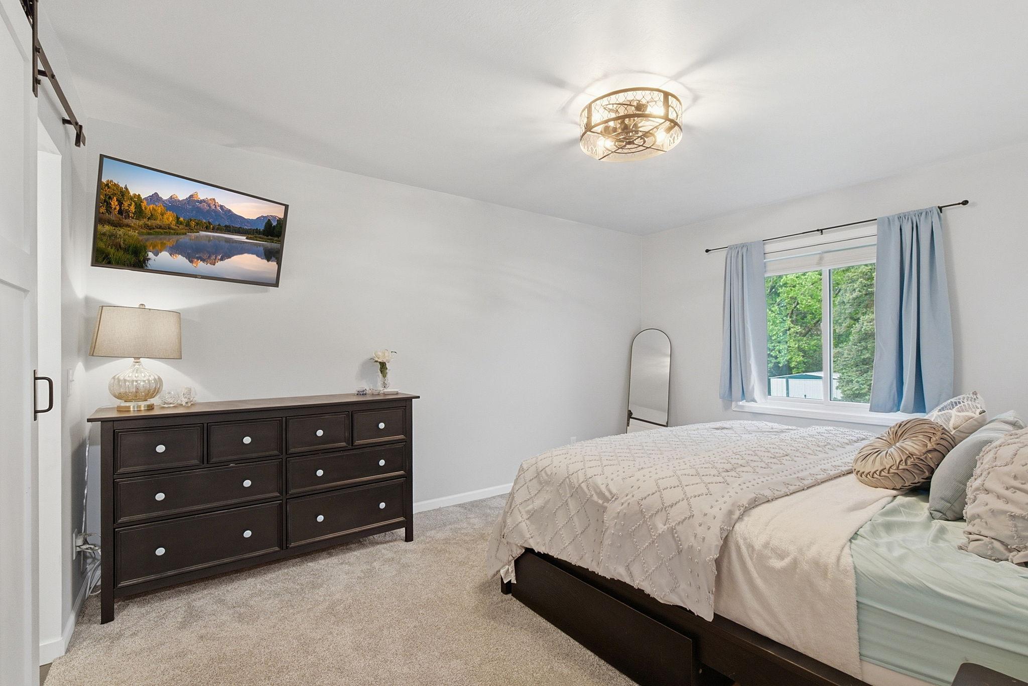 Primary bed on the upper level with en suite private bathroom and walk in closet