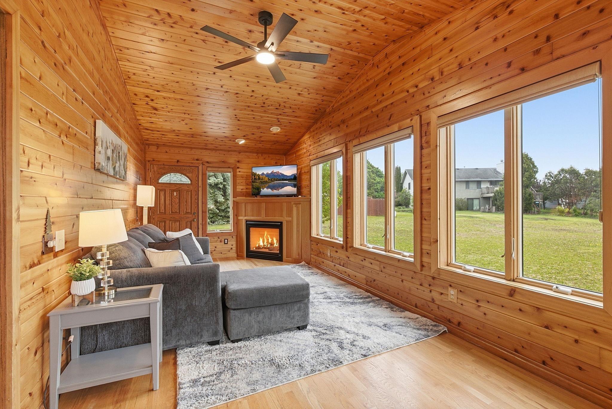 Cozy main floor porch with a tv area
