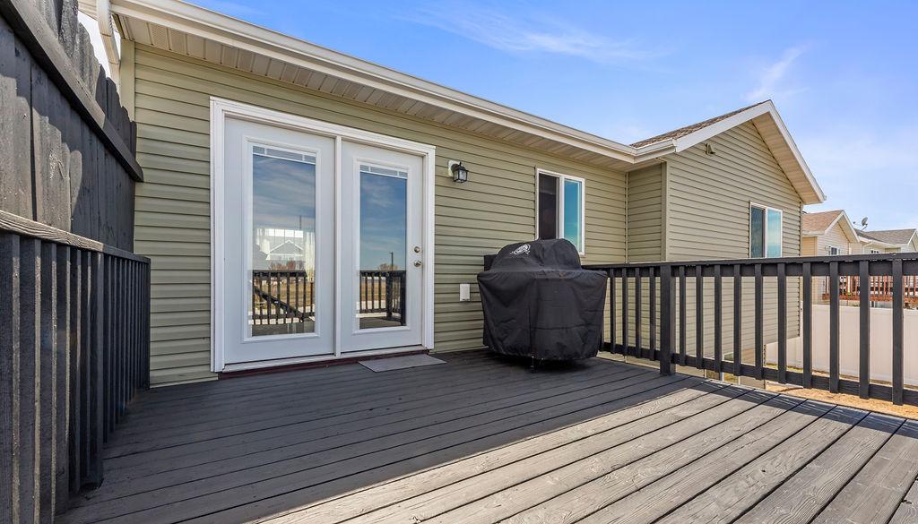 Patio door our to your large wood deck overlooking a fenced yard & no backyard neighbors