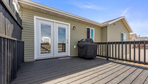 Patio door our to your large wood deck overlooking a fenced yard & no backyard neighbors