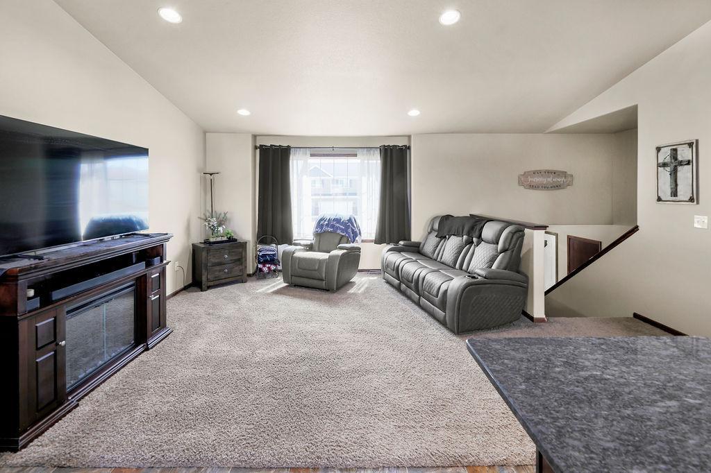 Living Room with vaulted ceilings, recessed lighting, open-concept living