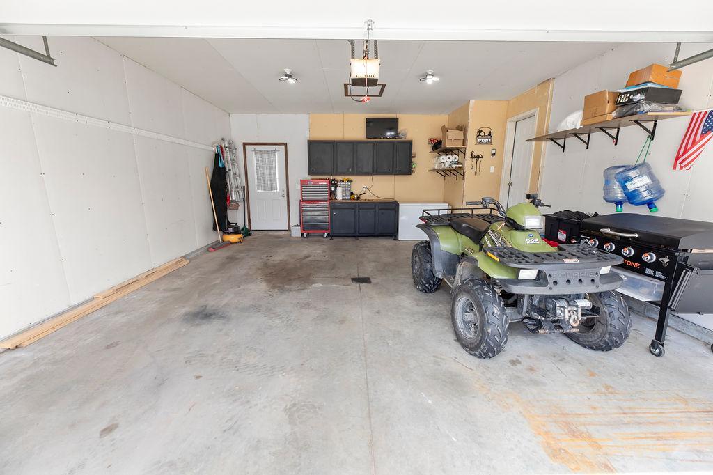 Garage has floor drain, backyard access, & space for storage