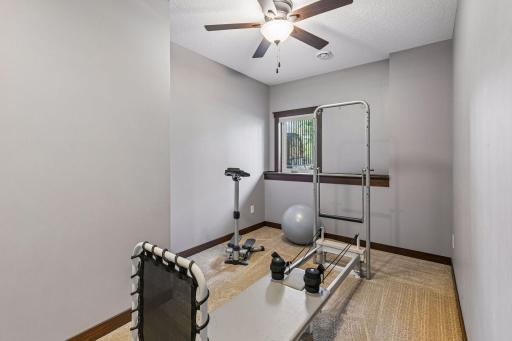 The private fourth bedroom offers generous space, abundant natural light, and flexibility as a guest suite, home office, fitness room, or hobby space.