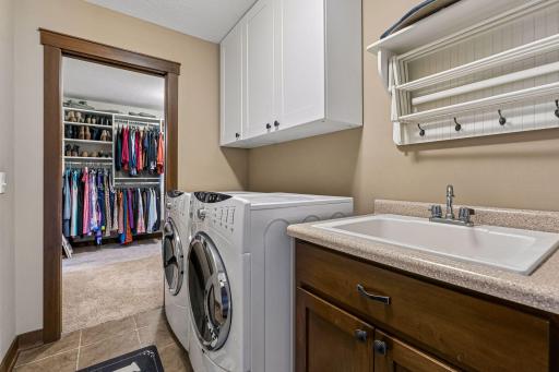 Conveniently located on the upper level, the laundry room features a utility sink, GE W/D, upper cabinetry, drying rack, and direct access to the spacious walk-in primary closetâmaking everyday chores exceptionally convenient.