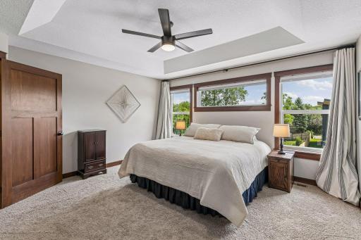 Designed for comfort and relaxation, the generous owner's suite offers room for a king-size bedroom set while showcasing large windows, elegant millwork, and tranquil backyard views.