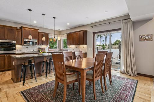 The spacious dining area sits adjacent to the gourmet kitchen and opens directly to the backyard through a large sliding glass door, making it ideal for family dinners, holiday celebrations, and summer entertaining.