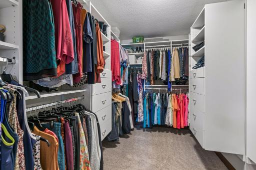 An impressive walk-in closet offers exceptional organization with custom built-in shelving, multiple hanging areas, drawers, and abundant storage to accommodate every wardrobe.