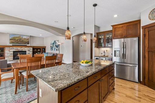 Gather around the island. With extensive storage, seating for casual dining, rich hardwood floors, and quality finishes throughout, this kitchen is both functional and welcoming for every occasion.