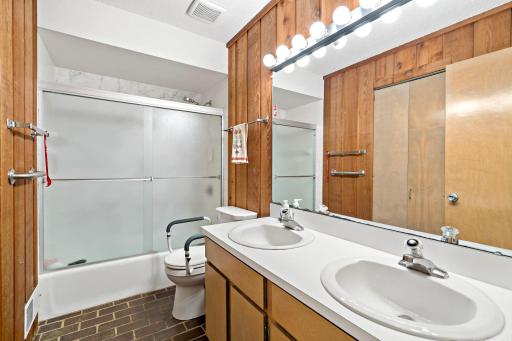 Main level bathroom with dual sinks.