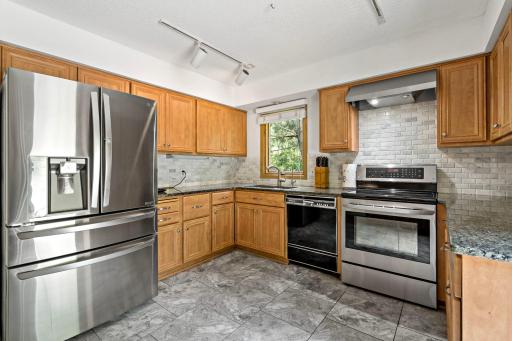 Remodeled kitchen that leads to the backyard deck and pool area.