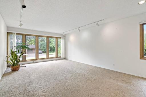 This main level room could be used as another living space, an office or sunroom, or a very spacious formal dining room.