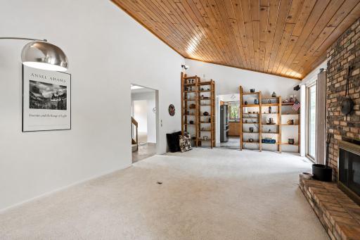 Living Room features vaulted ceiling and custom built-ins with lighting.