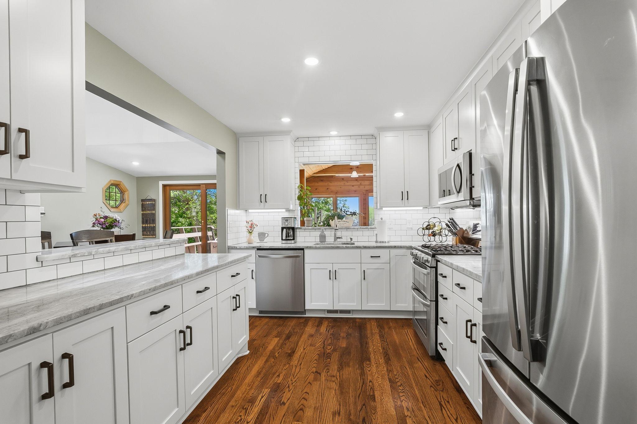 The kitchen has been beautifully remodeled, complete with stainless steel appliances, gas stove, passthrough to the four season and a breakfast bar.
