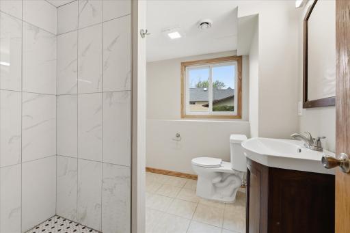 Enjoy this refreshed lower-level bathroom complete with a beautifully tiled shower