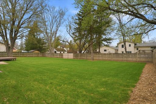 Enjoy this fully fenced backyard featuring lush green space and plenty of room to roam, play, and entertain!